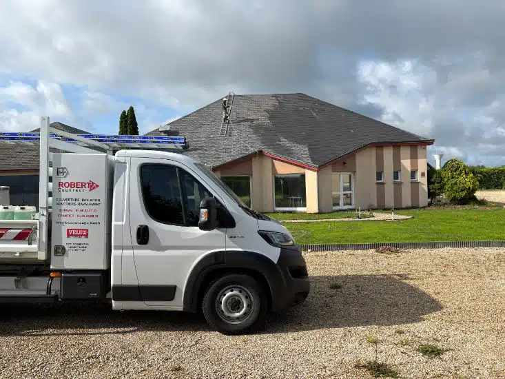 Camion Robert B. Couvreur devant un chantier de nettoyage de toiture, échelle de couvreur posée sur le toit